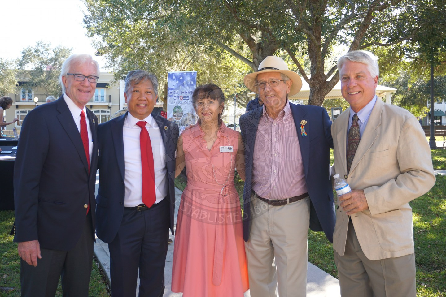 City of Winter Park mayor and commissioners all wearing business attire and posing for a picture smiling.
