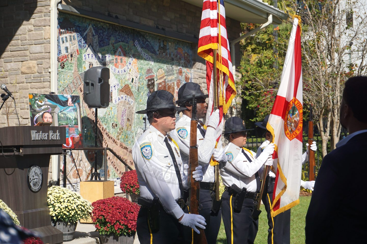 Winter Park Police Department Color Guard presenting colors in front of an audience.