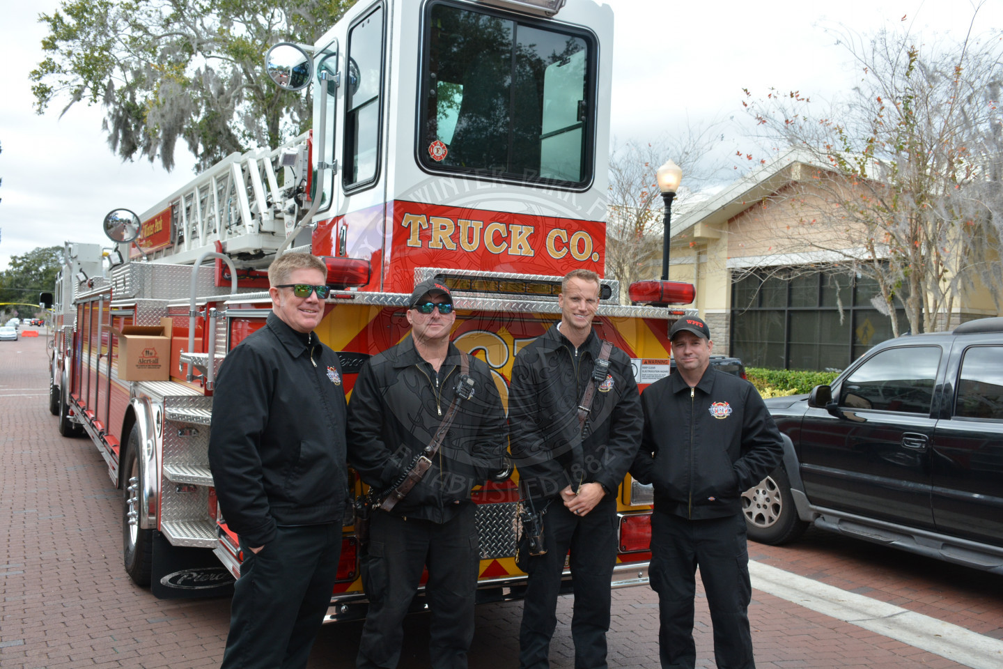 Four Winter Park Firefighters posing for photo in front of Engine 61