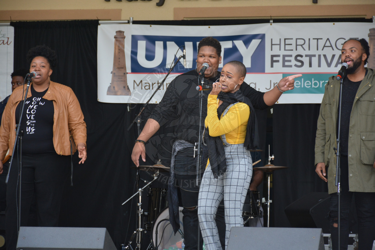 Group of four singers performing on the stage
