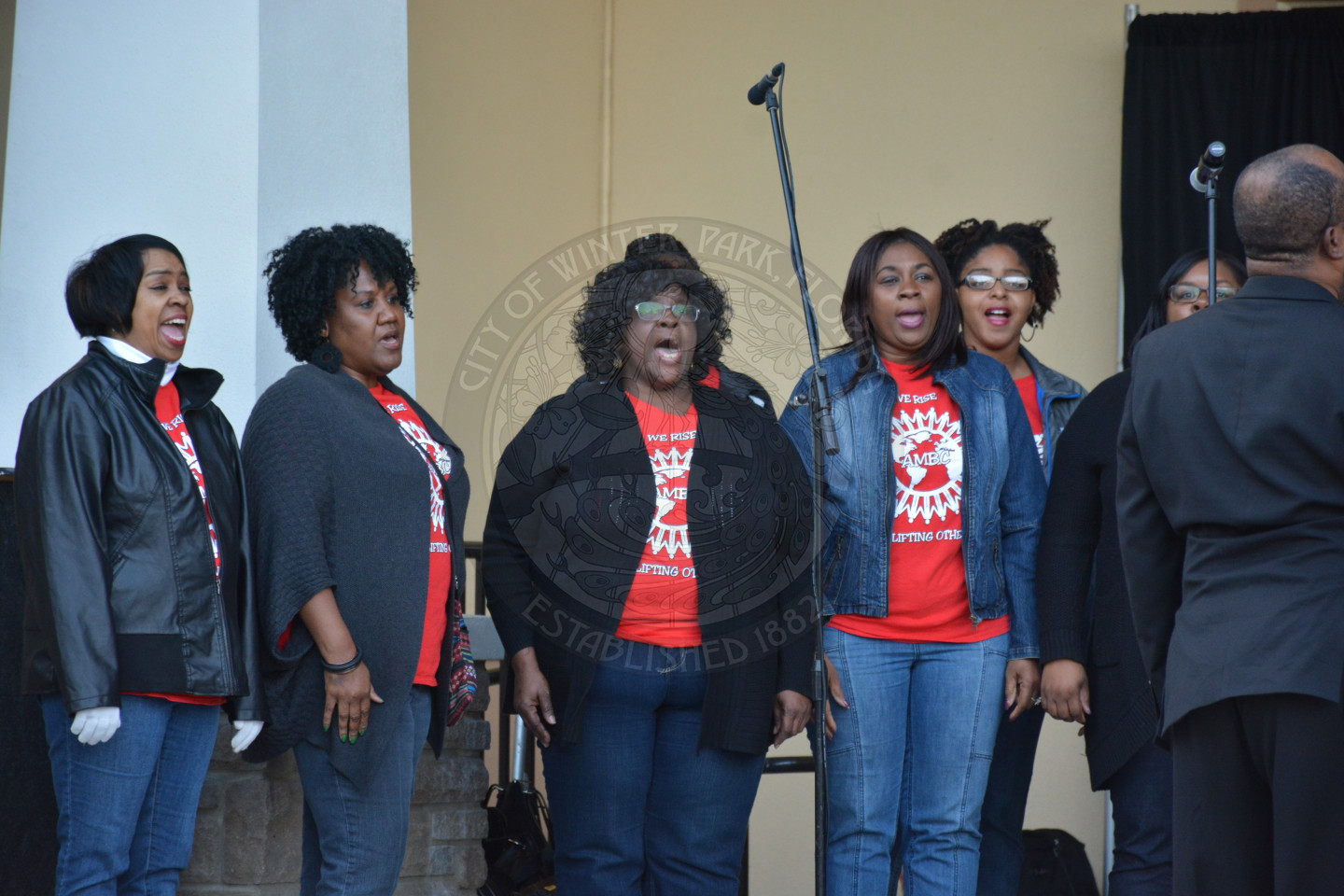 six female singers performing on stage