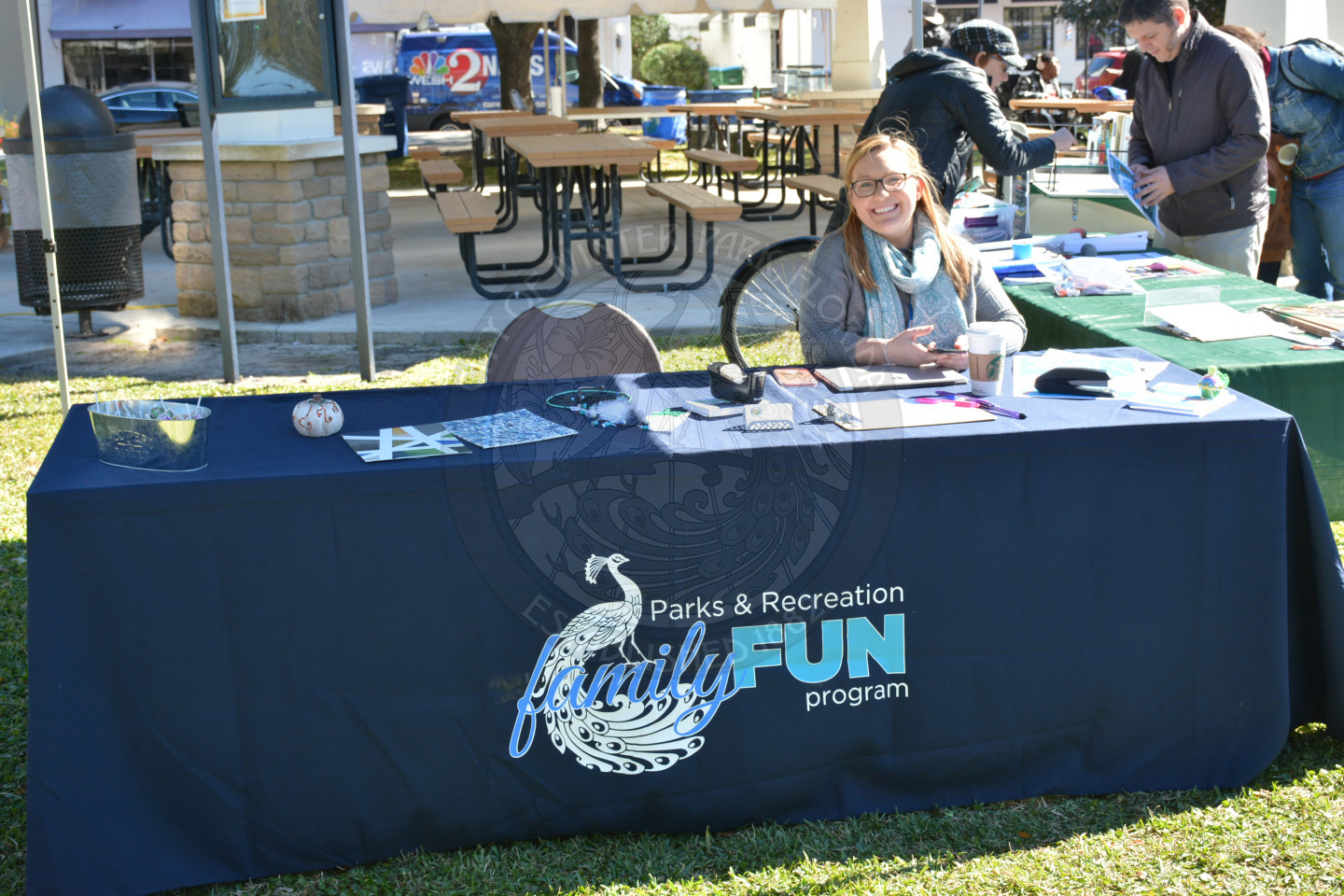 Parks and Recreation staff member seated at the Family Fun Program table