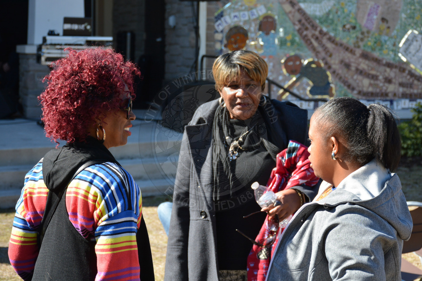 Group of three female attendees talking