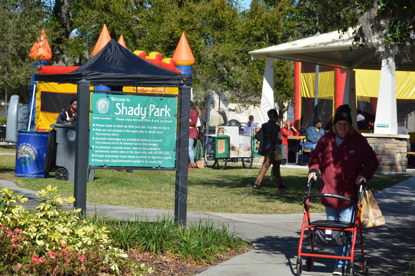 View of the Shady Park sign with an event attendee walking beside it