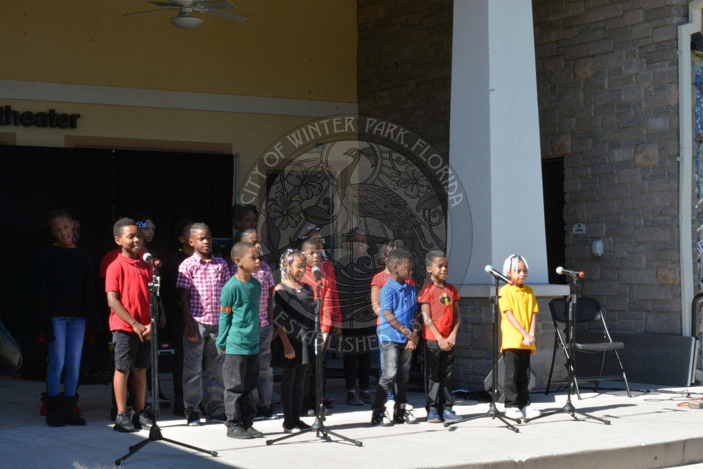 group of kids singing on outdoor ampitheatre