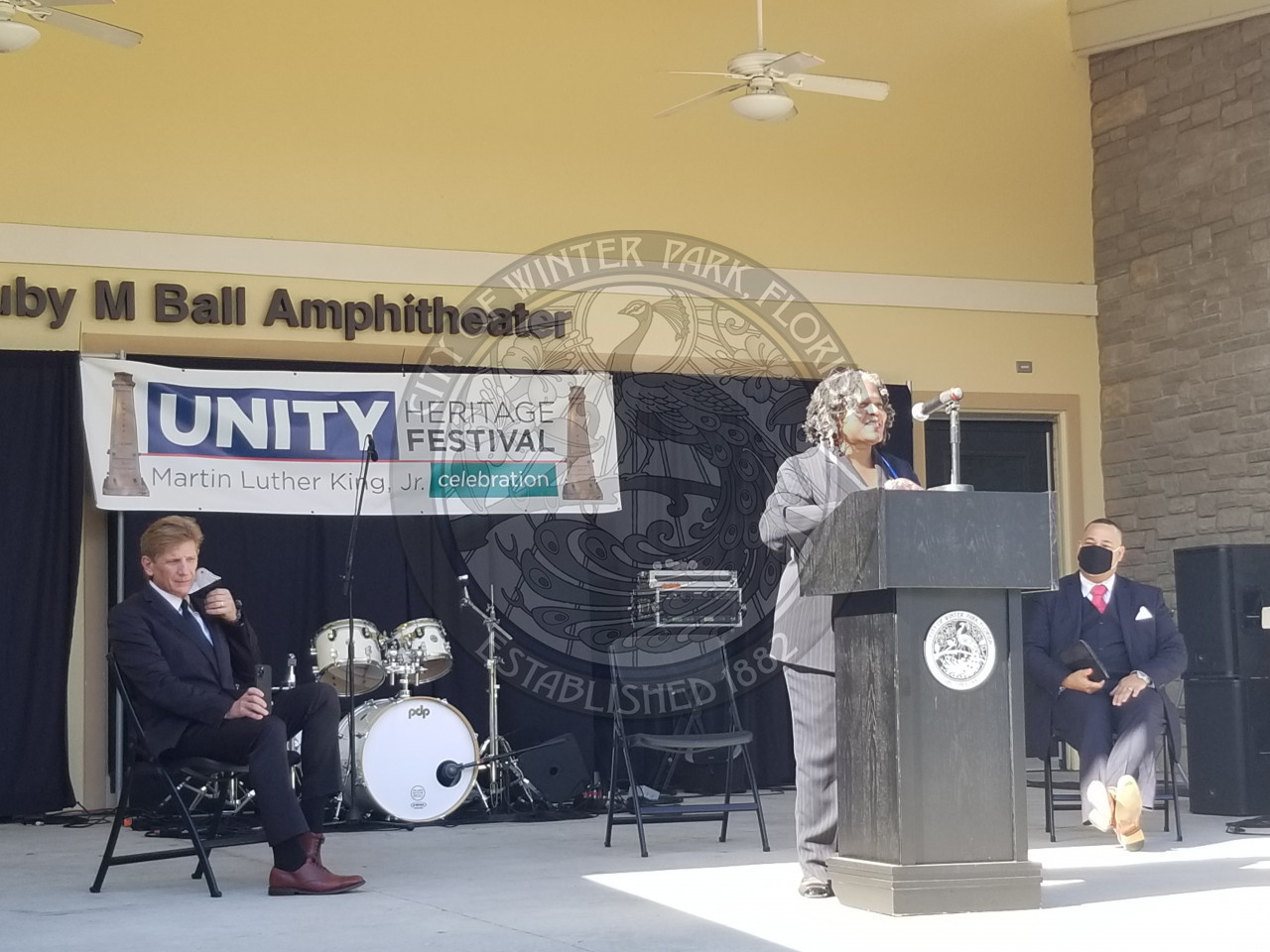Woman in front of podium speaking at Unity Heritage Festival