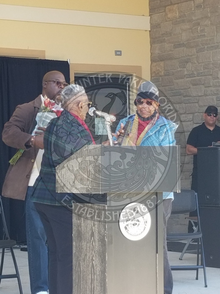 Woman presenting an award to another woman at the Unity Heritage Festival