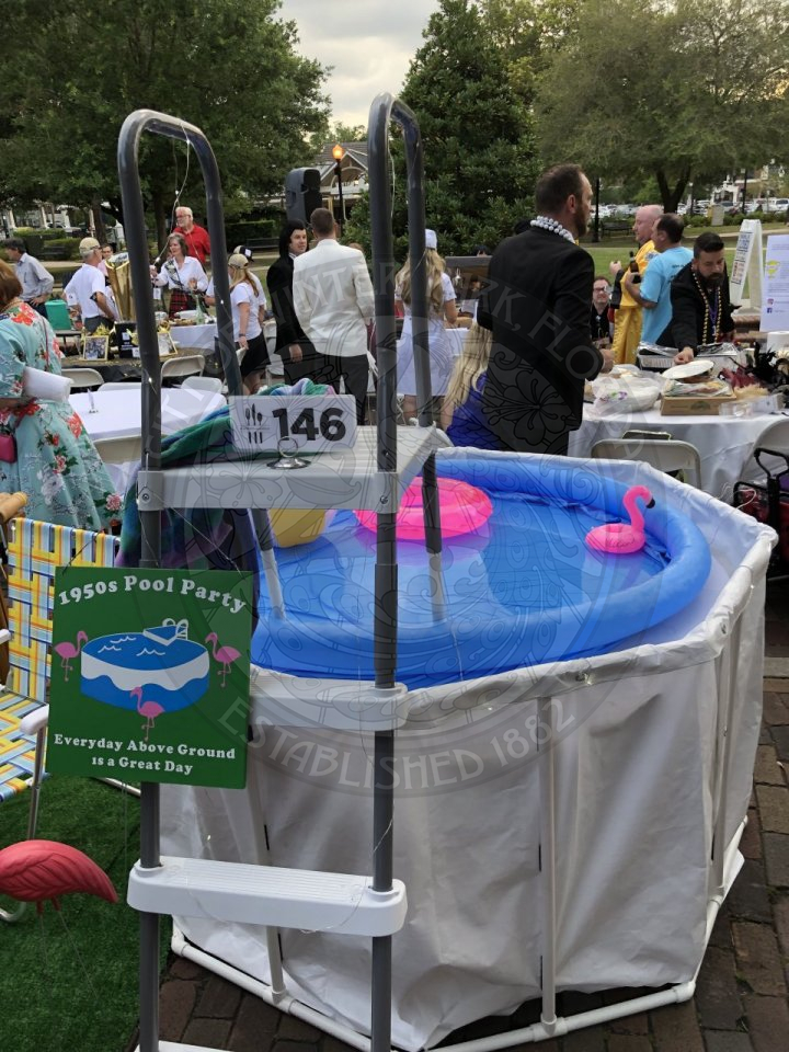 1950's pool party table with a floating flamingo in the pool.