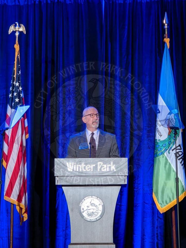 man behind podium on stage
