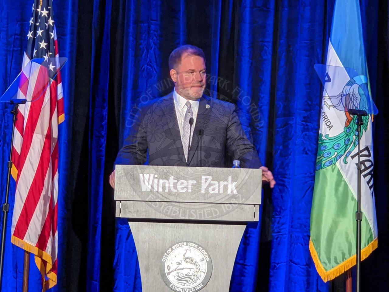 Mayor Steve Leary on stage behind the podium