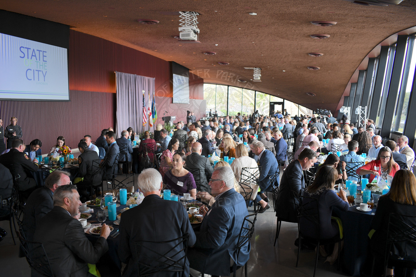 banquet hall with men and women sitting at tables eating