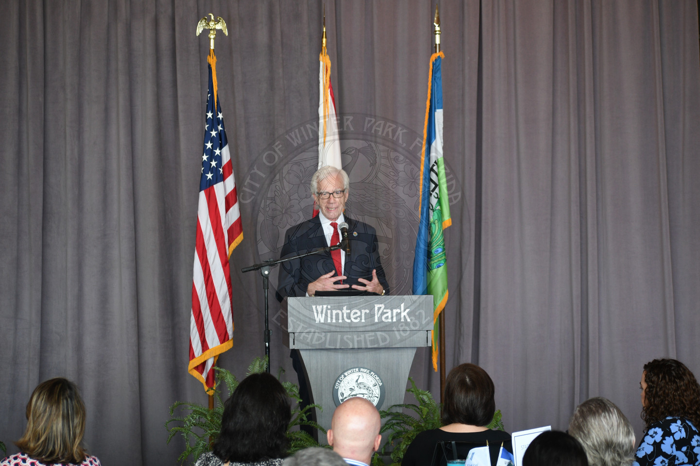 Mayor Phil Anderson talking into micorphone behind podium
