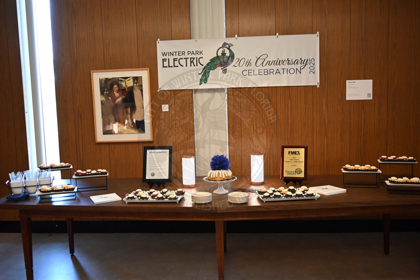 cupcakes, napkin, utensils, with awarded frames set up on a table.