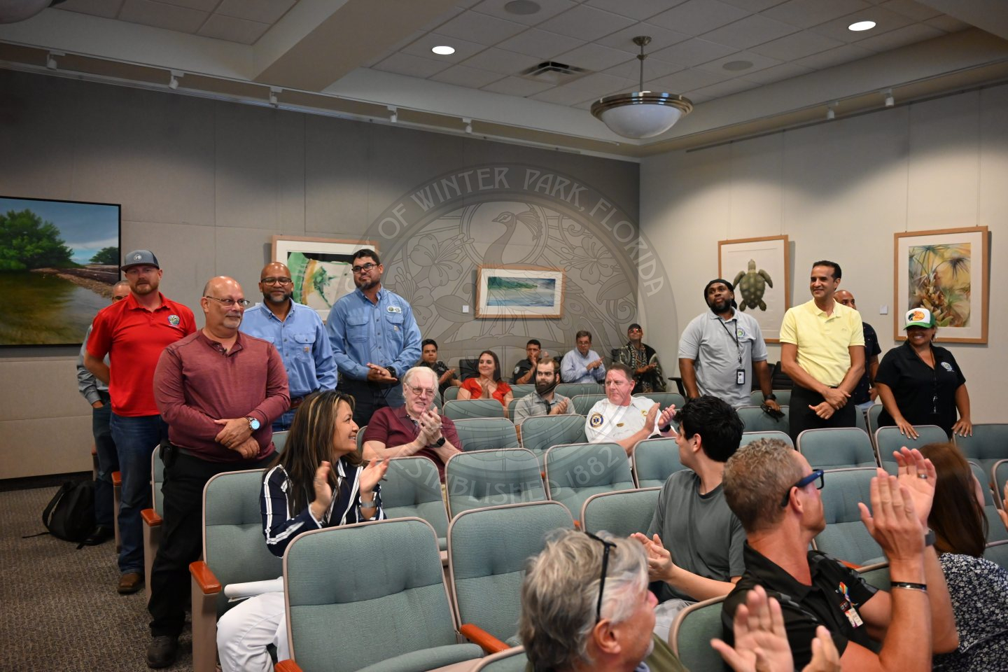 electric utility staff members standing up getting recognized by others.