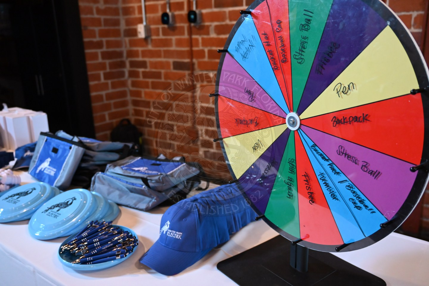 a colorful spin wheel with prizes on the table for spinning the wheel.