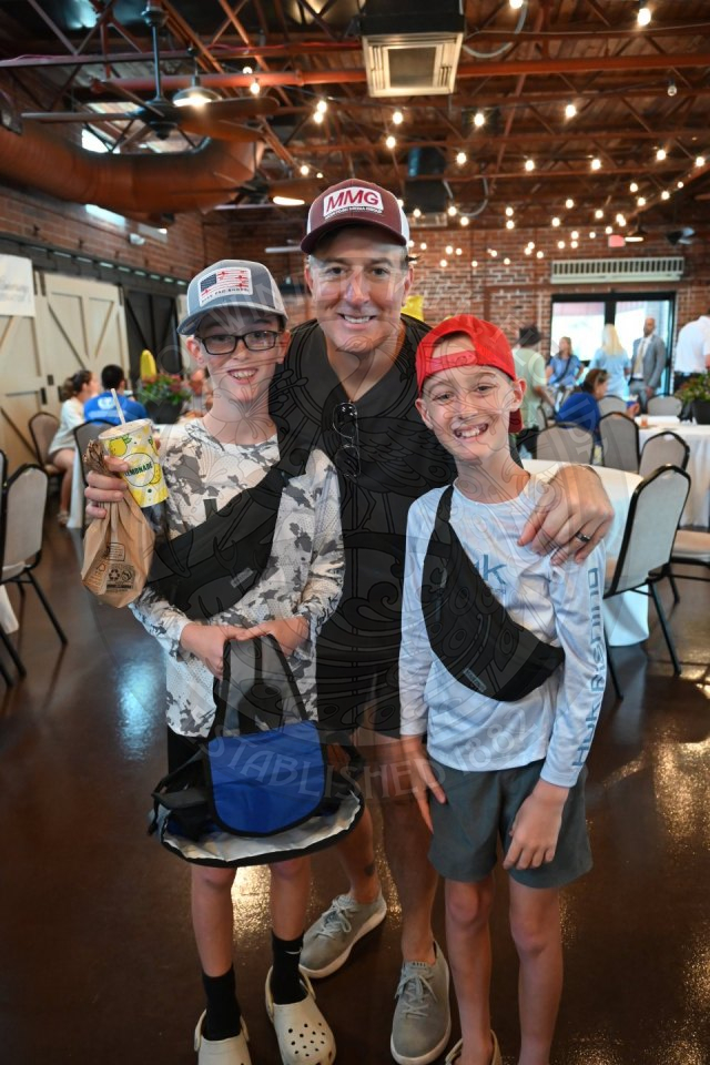 a dad and his two kids smiling.