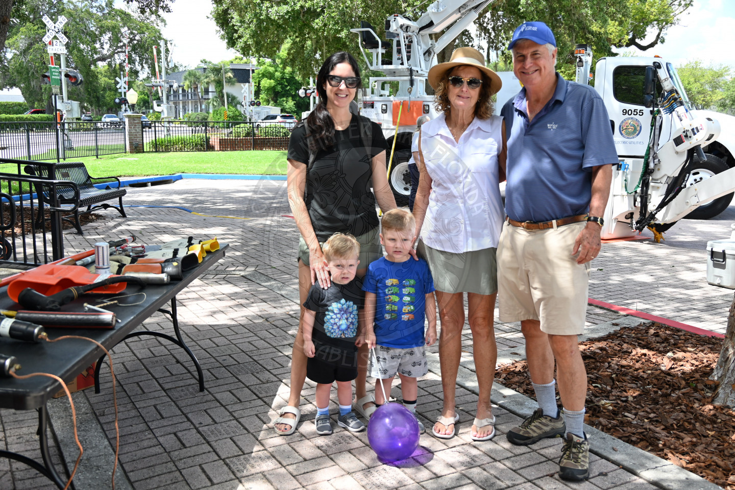 a family smiling while standing next to each other.