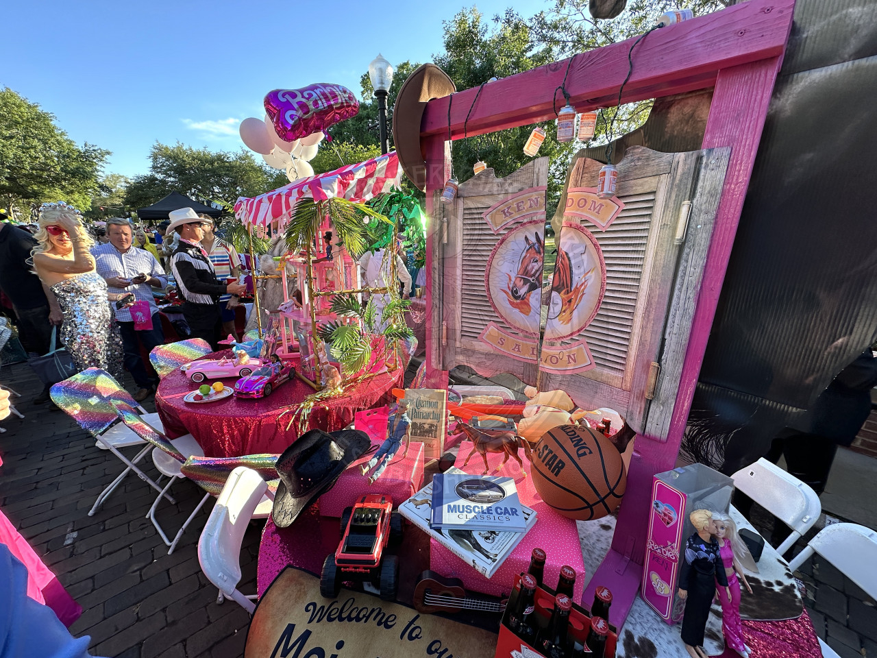 2 barbie themed tables that have kendoms sallooon on one of them and beach barbie decor on the other.