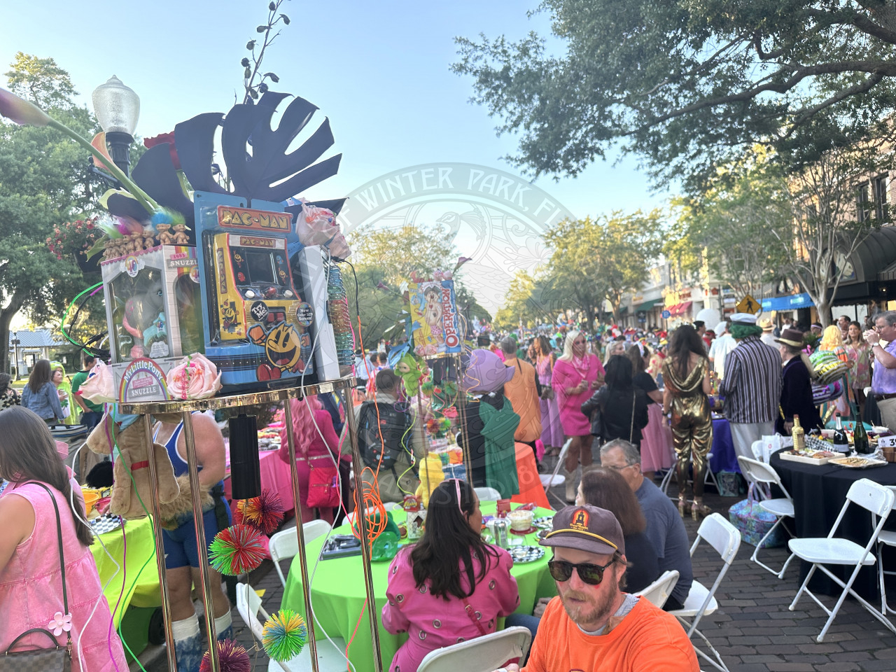 overview of all the tables on the park avenue with one in the front with old toys from the 1990s and neon colors. 