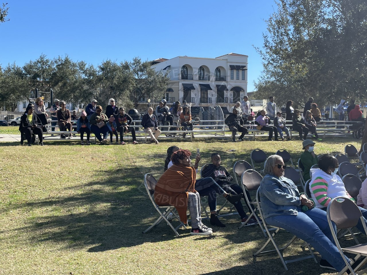 Crowd of people sitting in chairs and bleachers