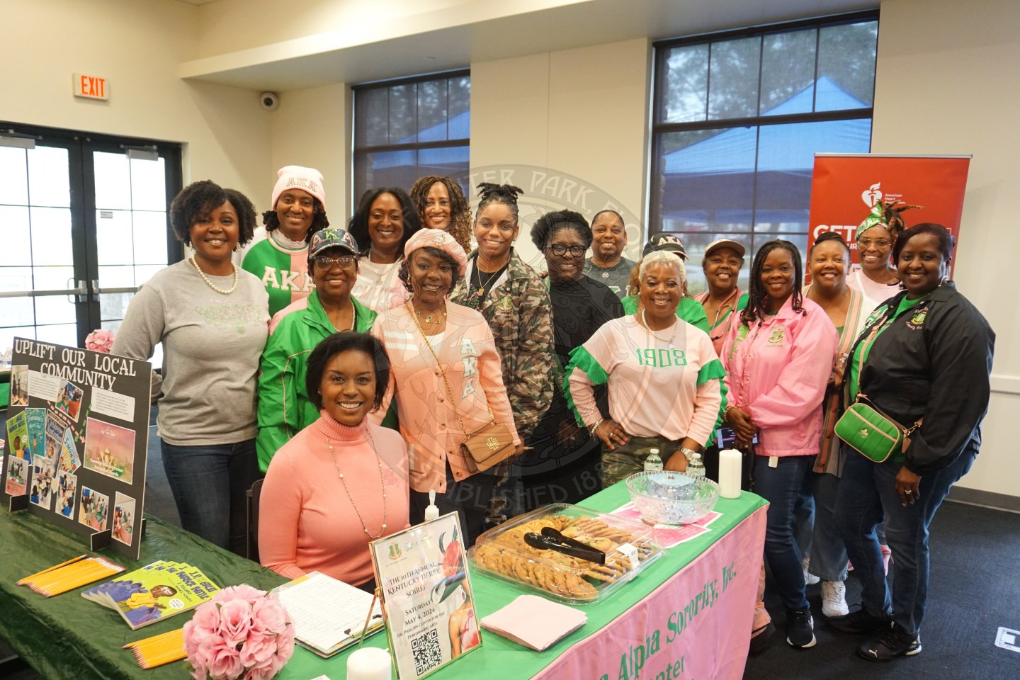 A gorup of females wearing pink and green representing a sorority.