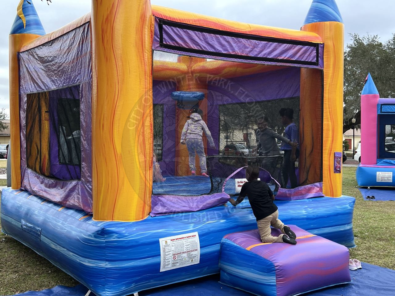 kids bouncing in an inflatable bounce house.
