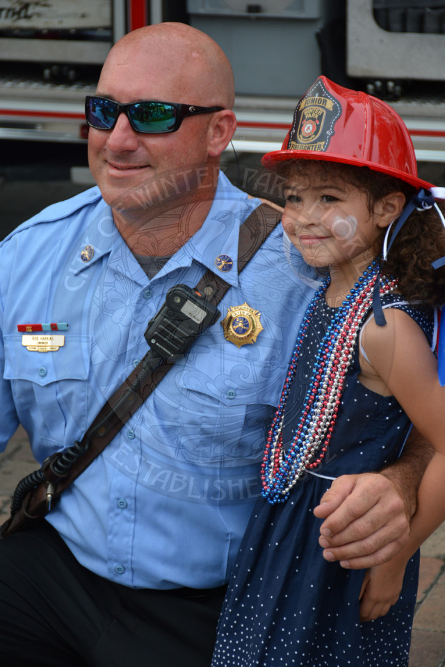 girl smiling with a firefighter