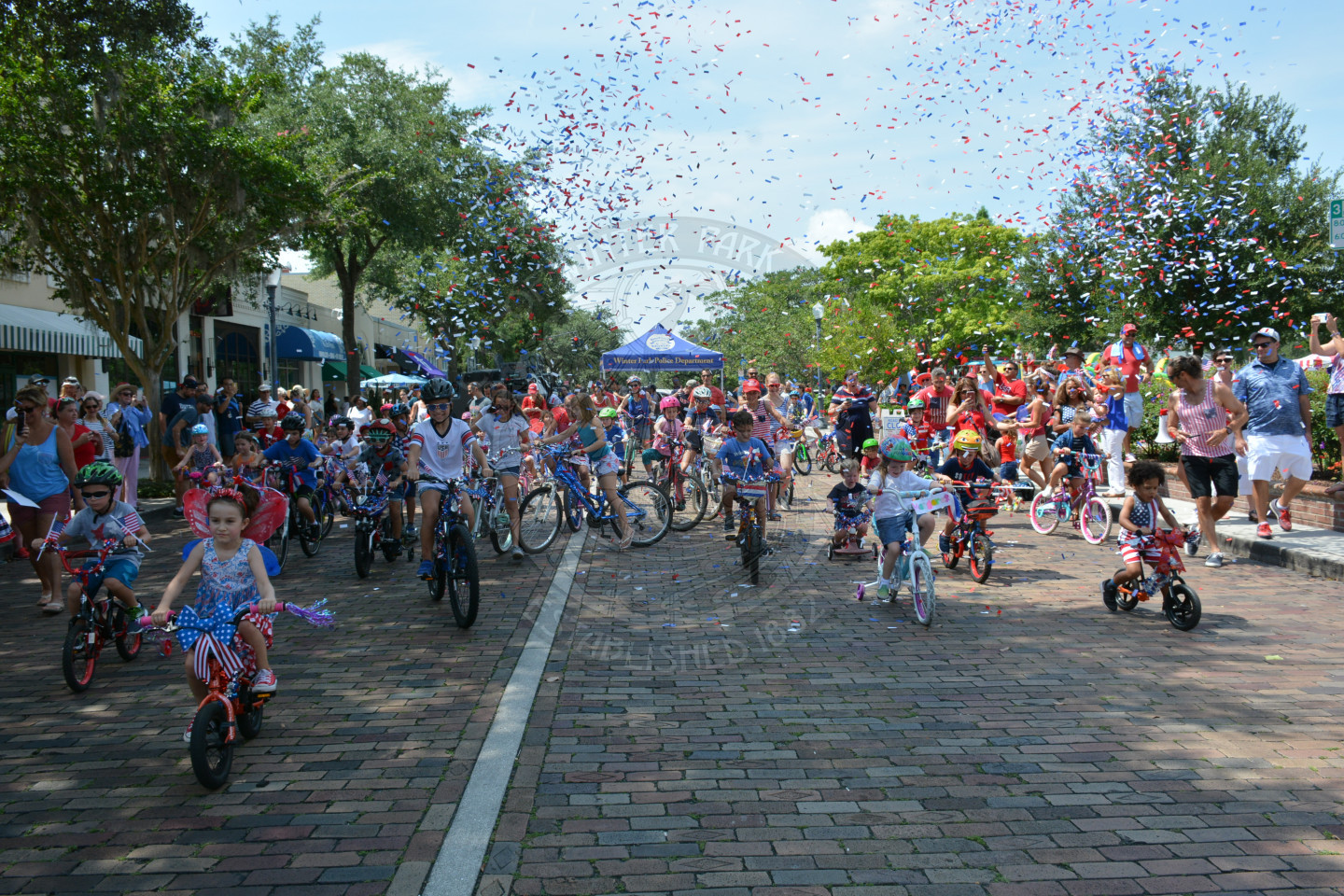 confetti shooting over kids riding bikes down park avenue