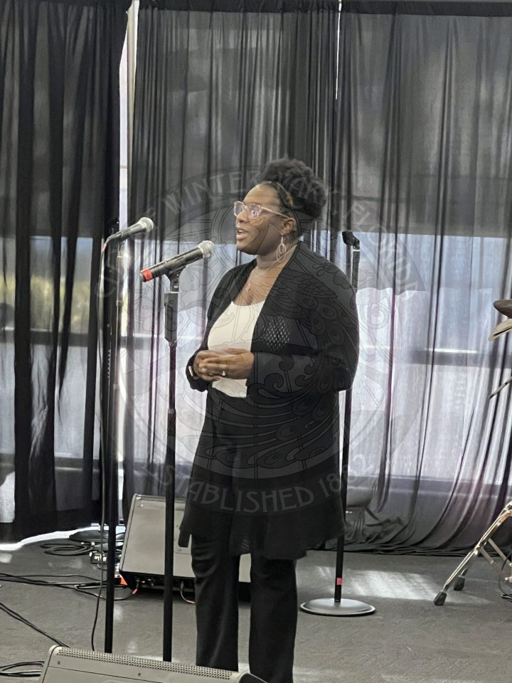 A woman singing into a mirophone.