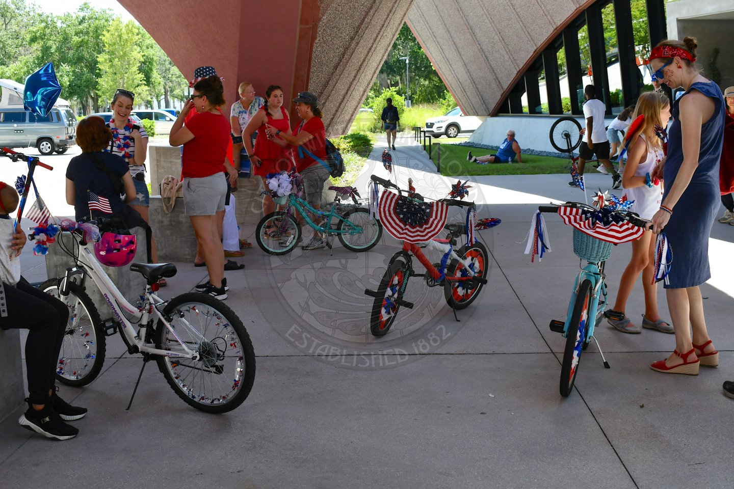 Bikes decorated with red, white, and blue patriotic items for the bike parade.