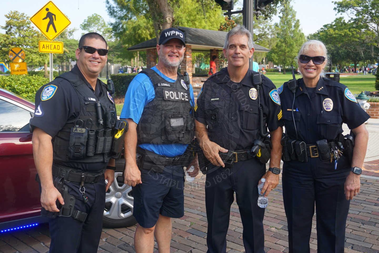 4 police officers standing together smiling
