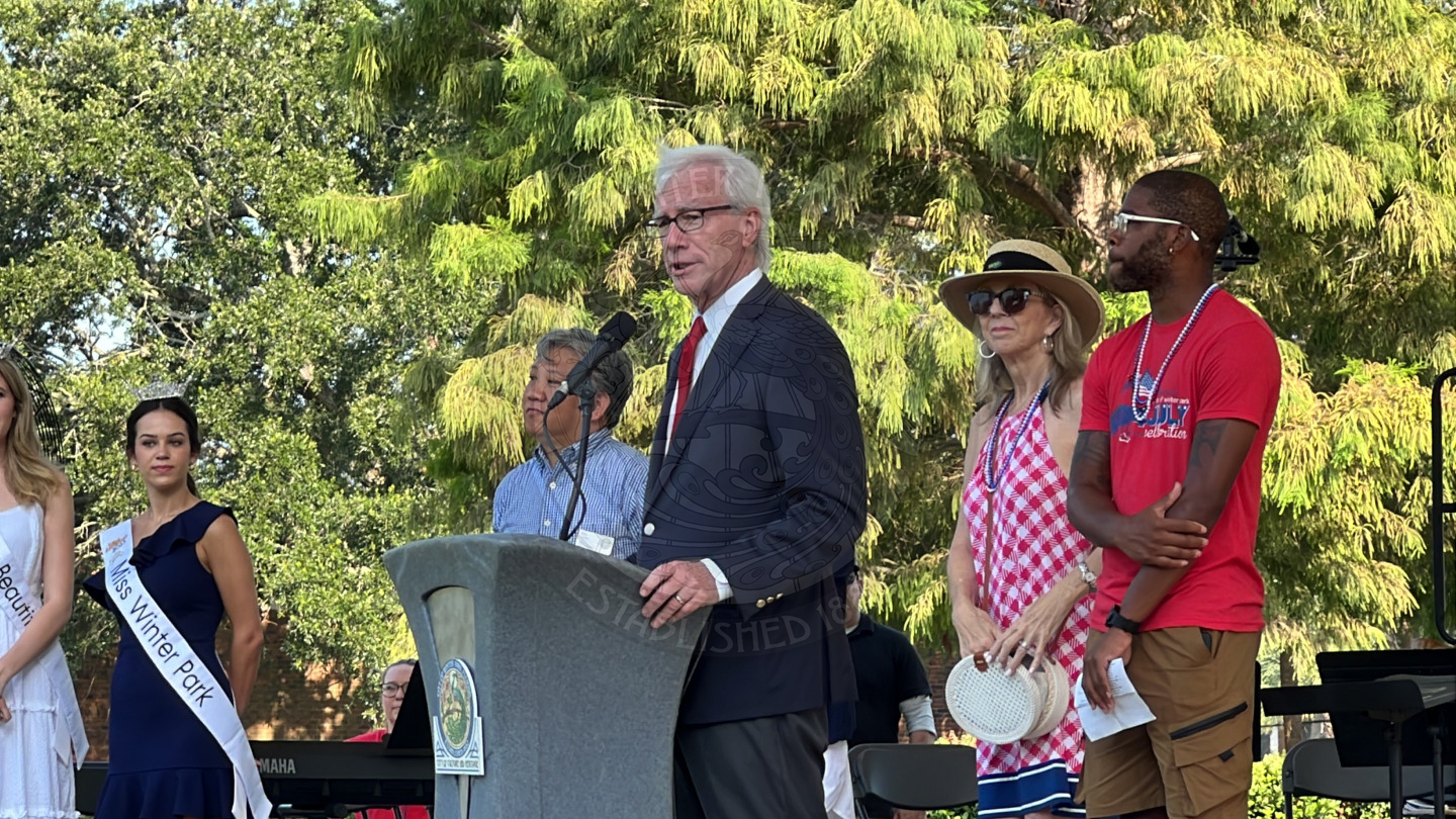 Mayor Phil Anderson standing behind the podium and talking to audience