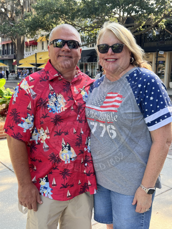 man and woman standing nexxt to each other smiling for the camera
