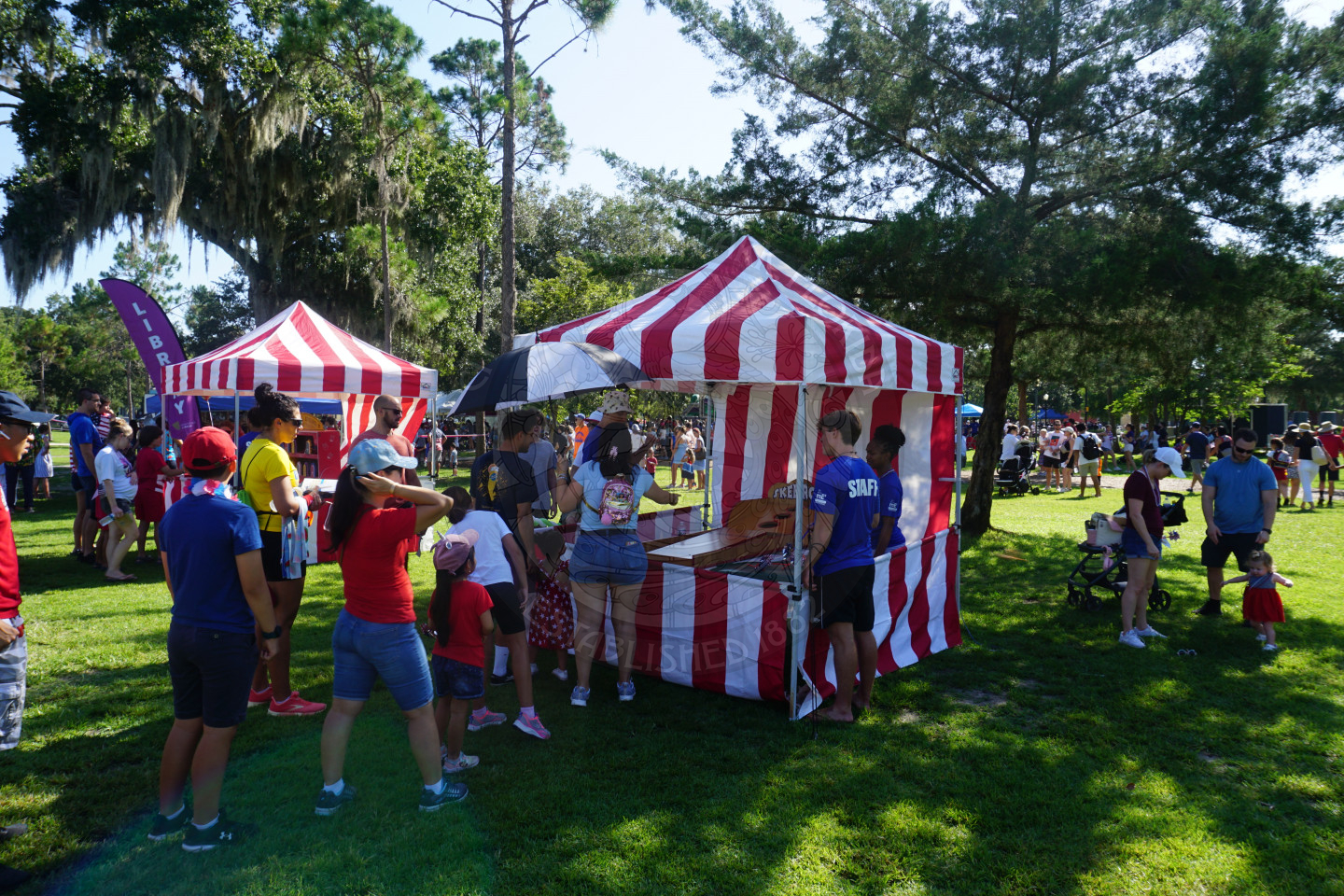 A carnival booth with a skeeball game to win a prize.