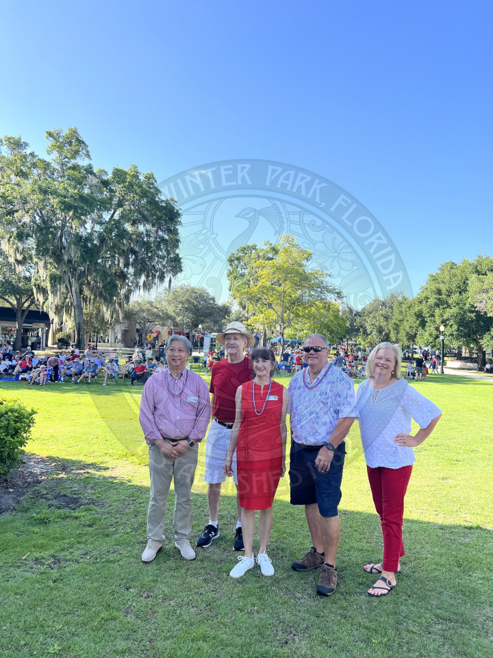 Commissioner Chris Kruzada, Commissioner Marty Sullivan, Mayor Shelia DeCiccio, City Manager Randy Knight, and Assitant City Manager wearing red, white and blue posing.