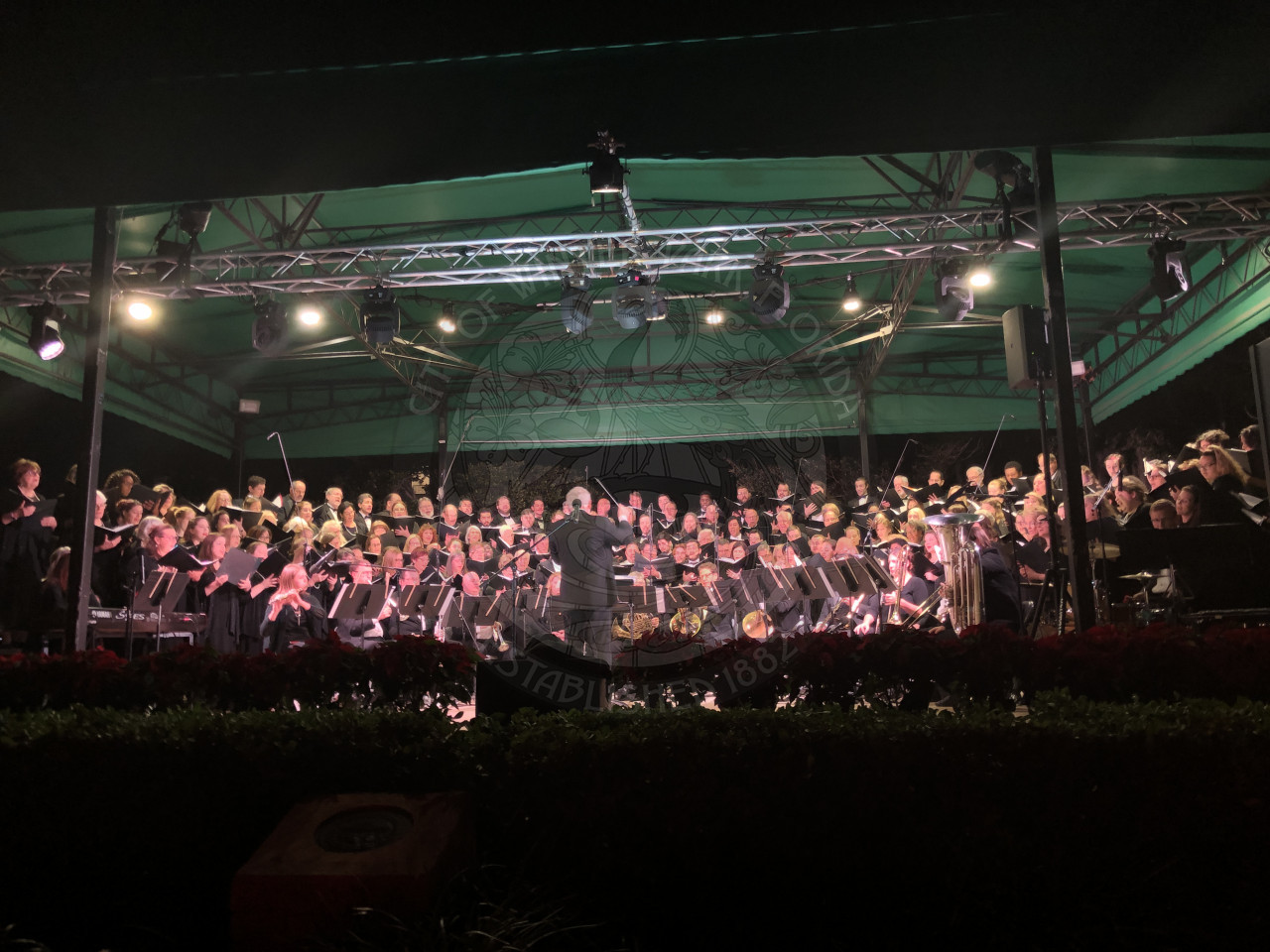Bach Festival Society brass ensemble and choir on stage performing