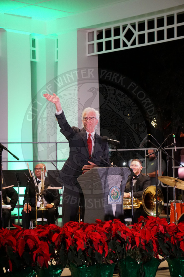 Mayor Phil Anderson standing on the stage waving