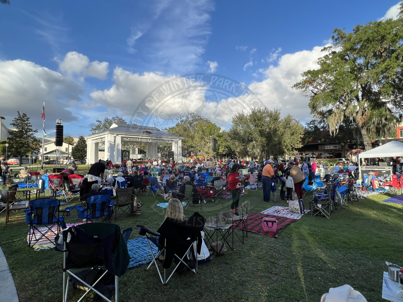 the audience sitting in front of the stage at Christmas in the Park