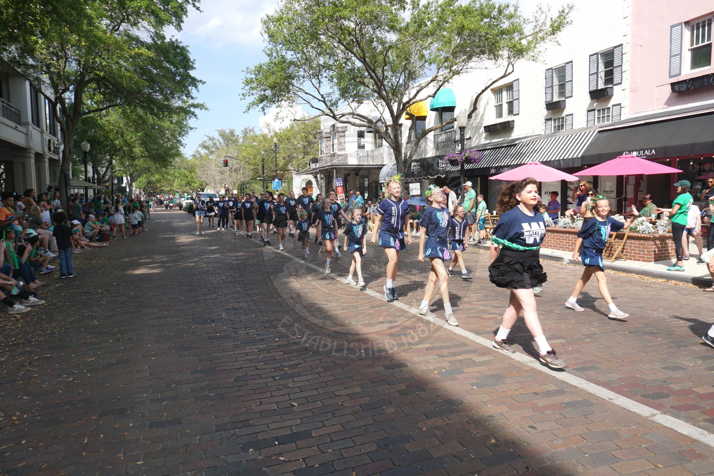Children irish dancing in two straight lines next to each other down park avenue