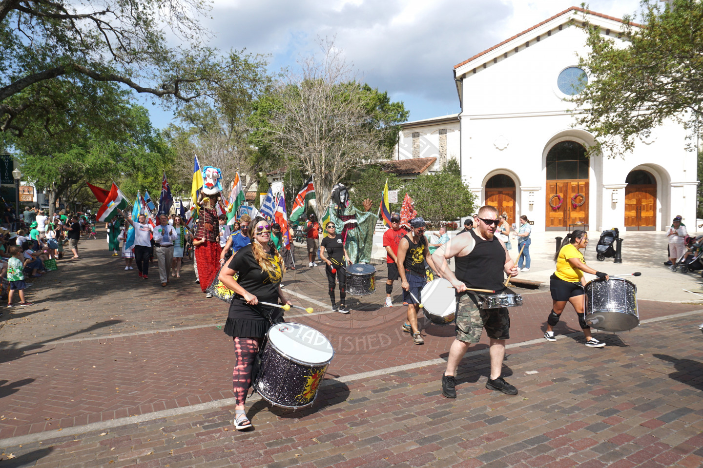 group f people walking an dplaying drums