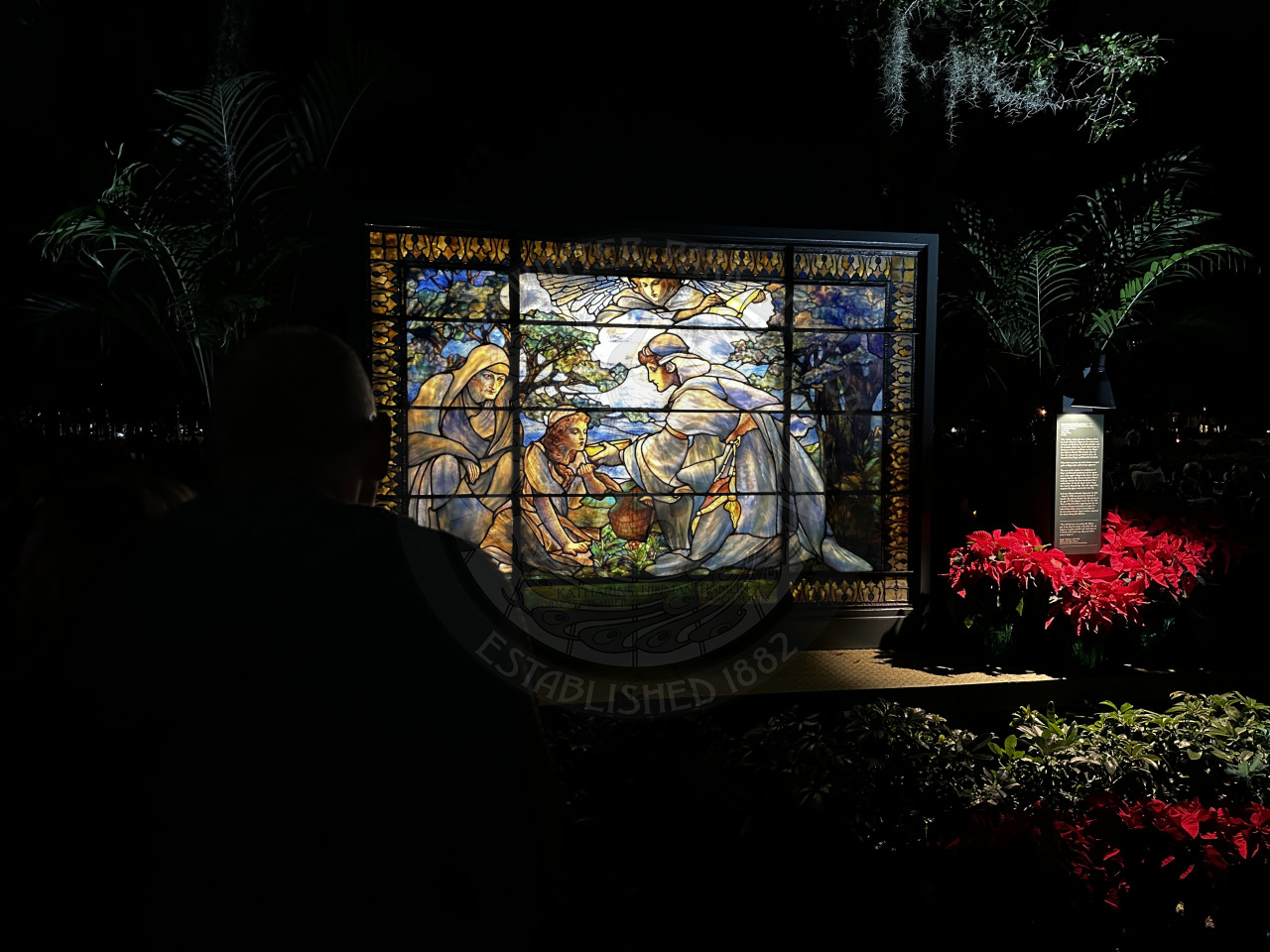 a stained glass window with three people on it.