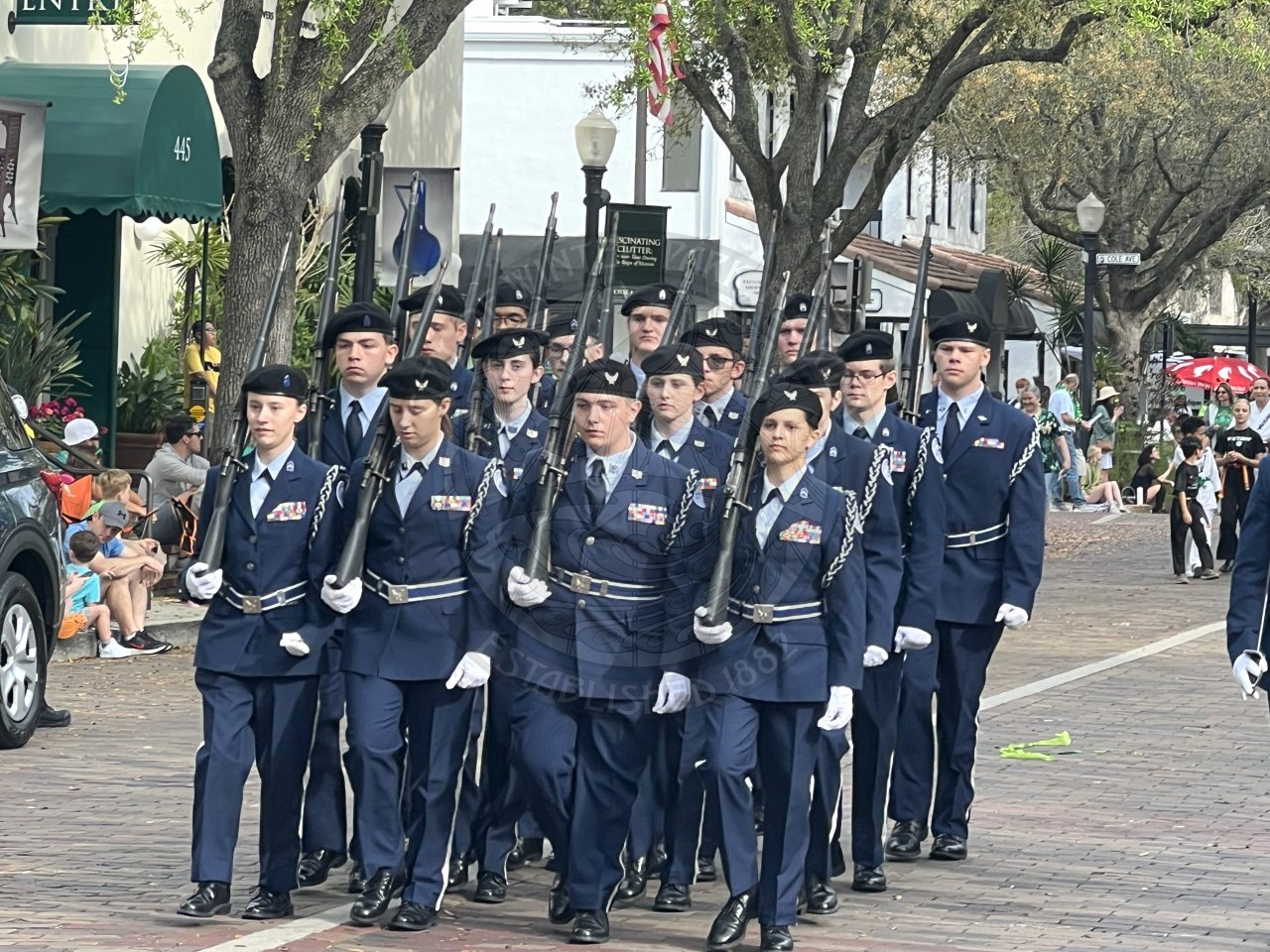 Group of uniformed kids marching down park avenue.