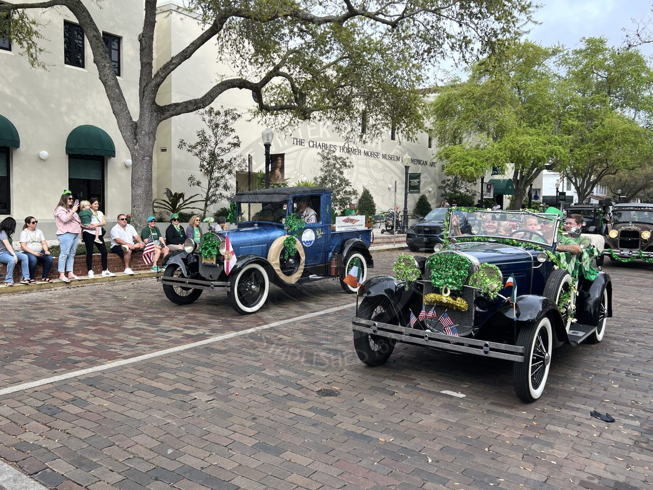 a line of old trucks driving down park avenue