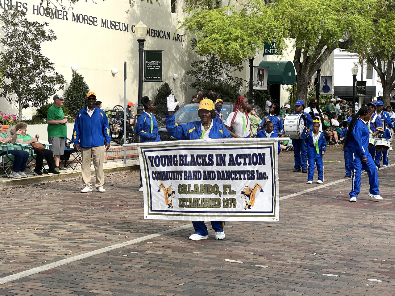 Young Black in Action Community Band marching down Park avenue playing their insturments 