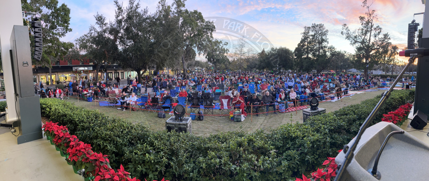 a panaromic view of the crowd sitting in front of stage for the concert.