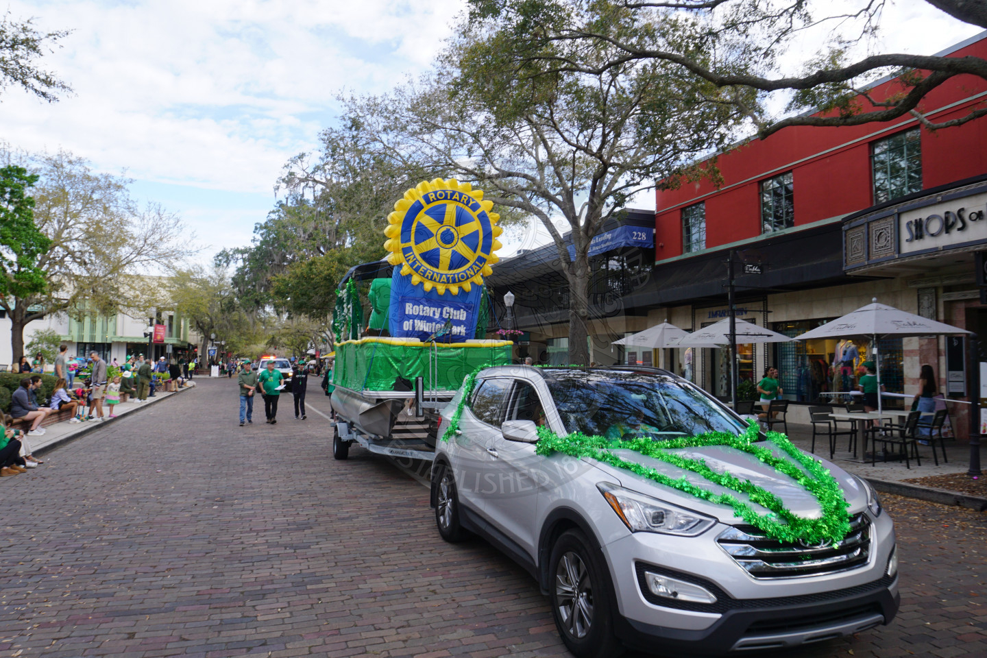 Rotary Club blow up on a boat riding down a brick street.
