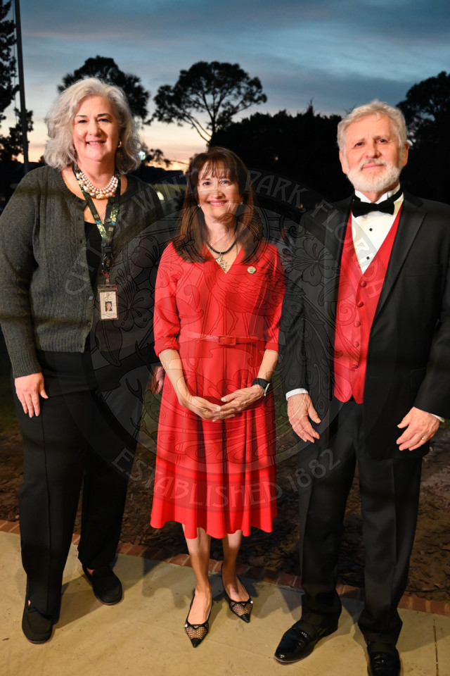 two women and a man standing next to each other.