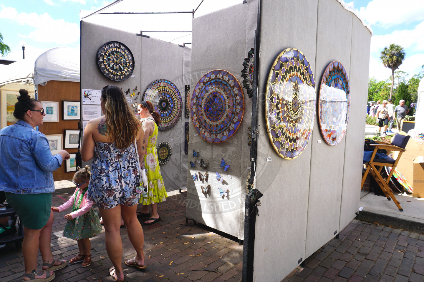 People looking at tent with art