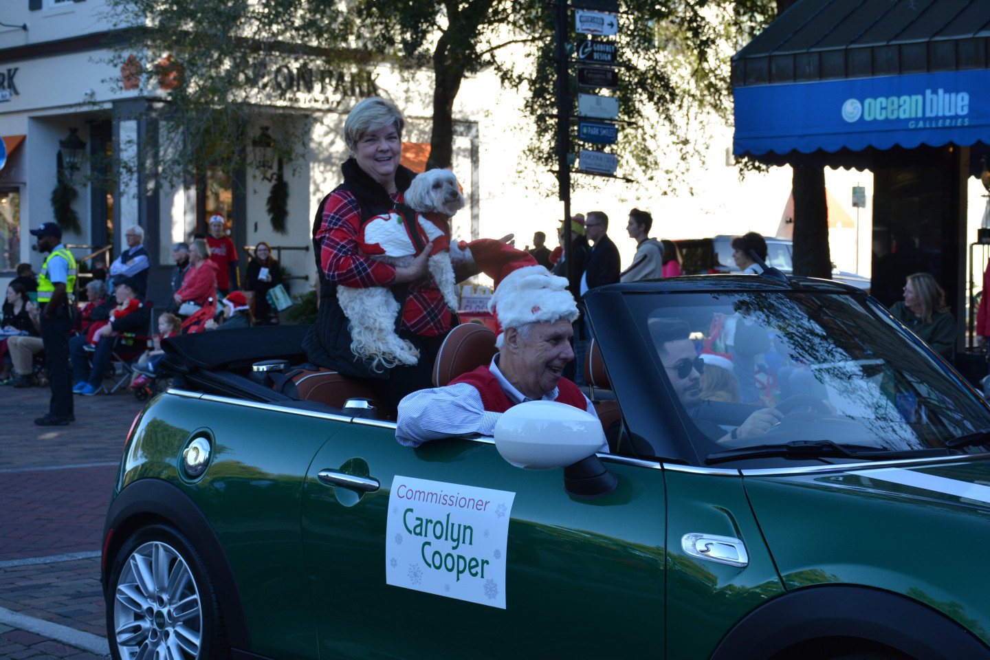 Commissioner Cooper and her dog smiling in the back of a car during the parade
