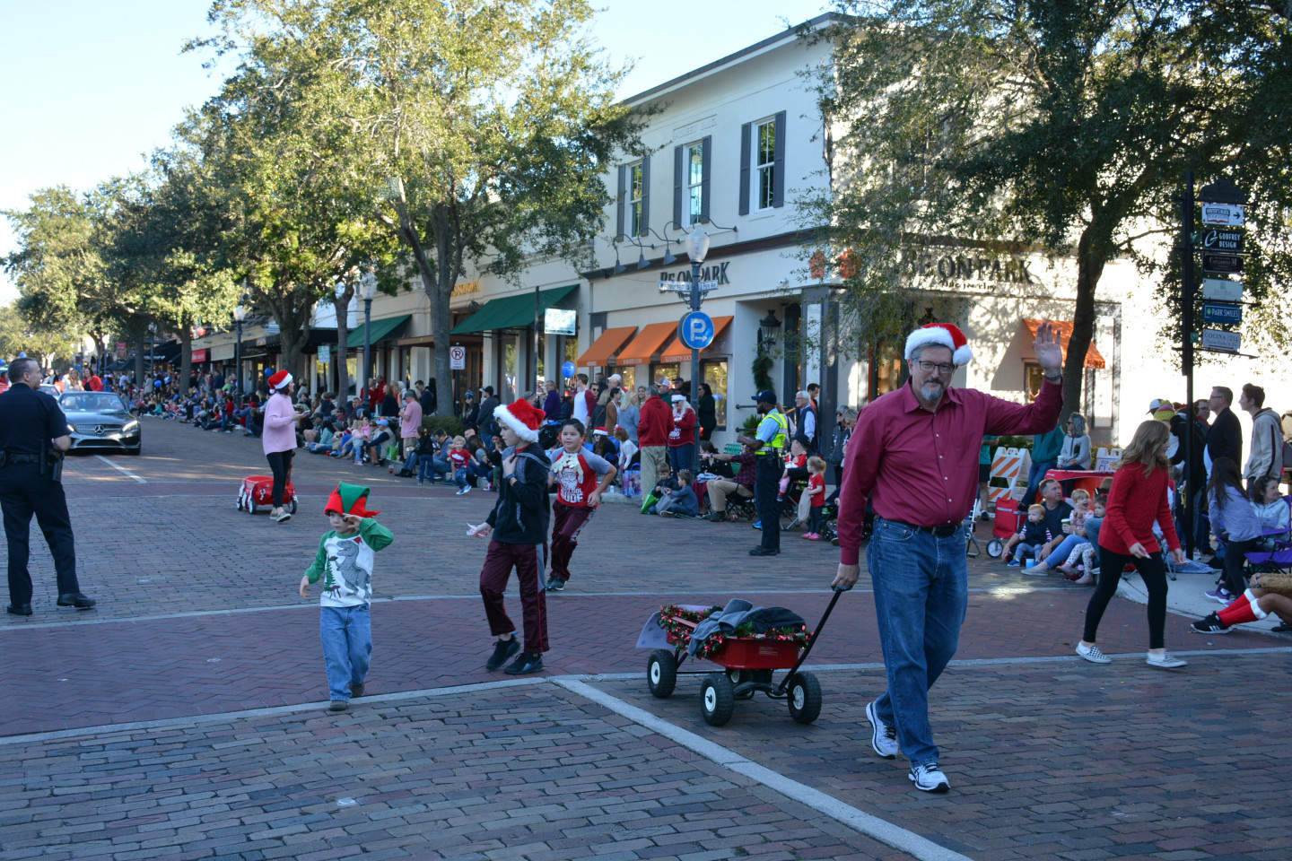 Commissioner Seidel pulling a wagon and waving during the parade